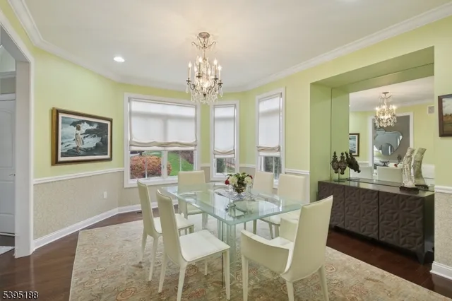 a view of a dining room with furniture a chandelier and wooden floor