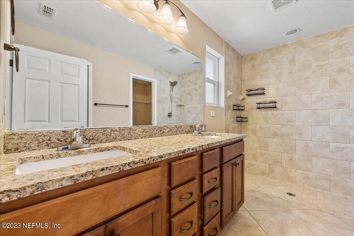 5418 Manfields Place Jacksonville, FL 32207 - Photo 13 of 21 a bathroom with a granite countertop sink and a mirror