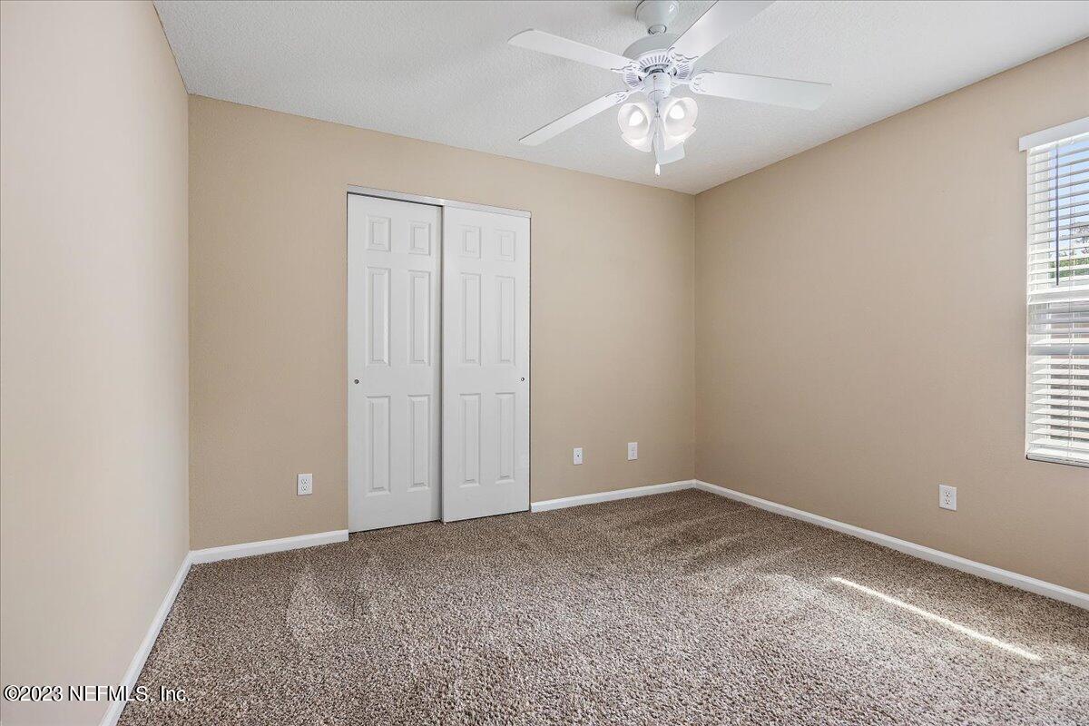 5418 Manfields Place Jacksonville, FL 32207 - Photo 15 of 21 an empty room with windows and fan