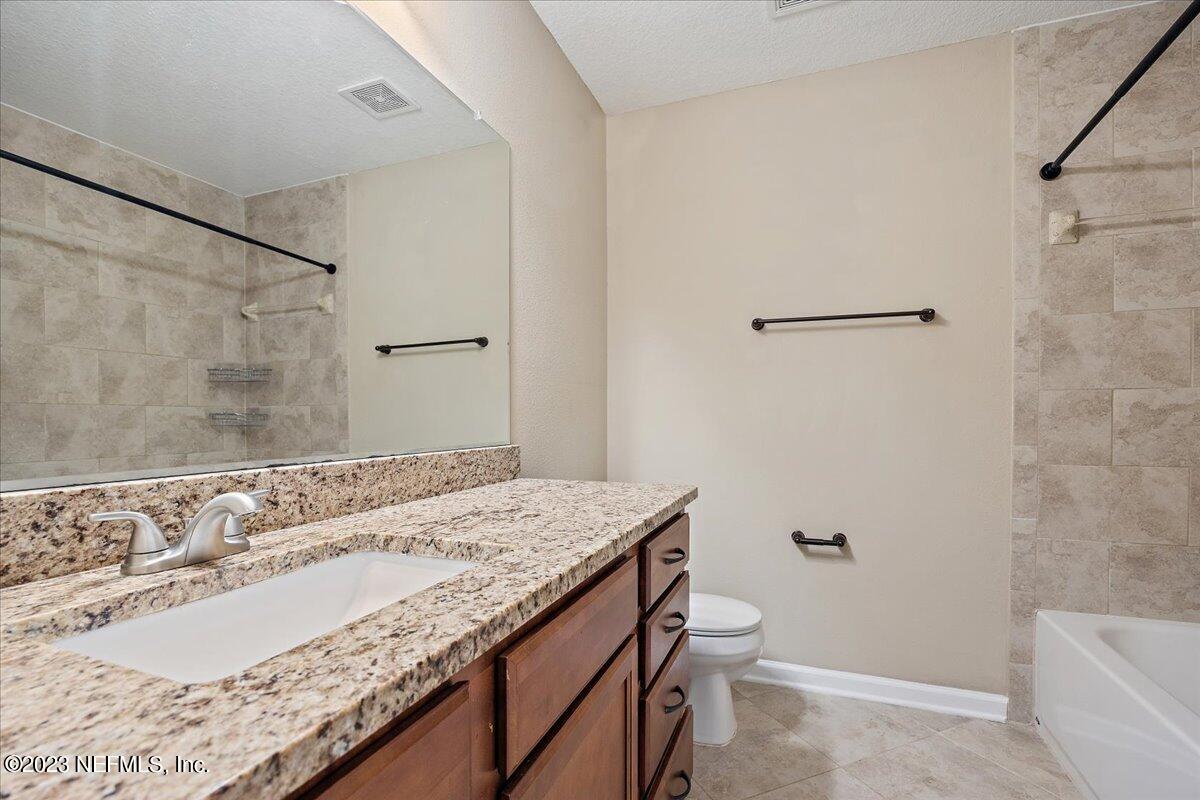 5418 Manfields Place Jacksonville, FL 32207 - Photo 17 of 21 a bathroom with a granite countertop sink and a mirror