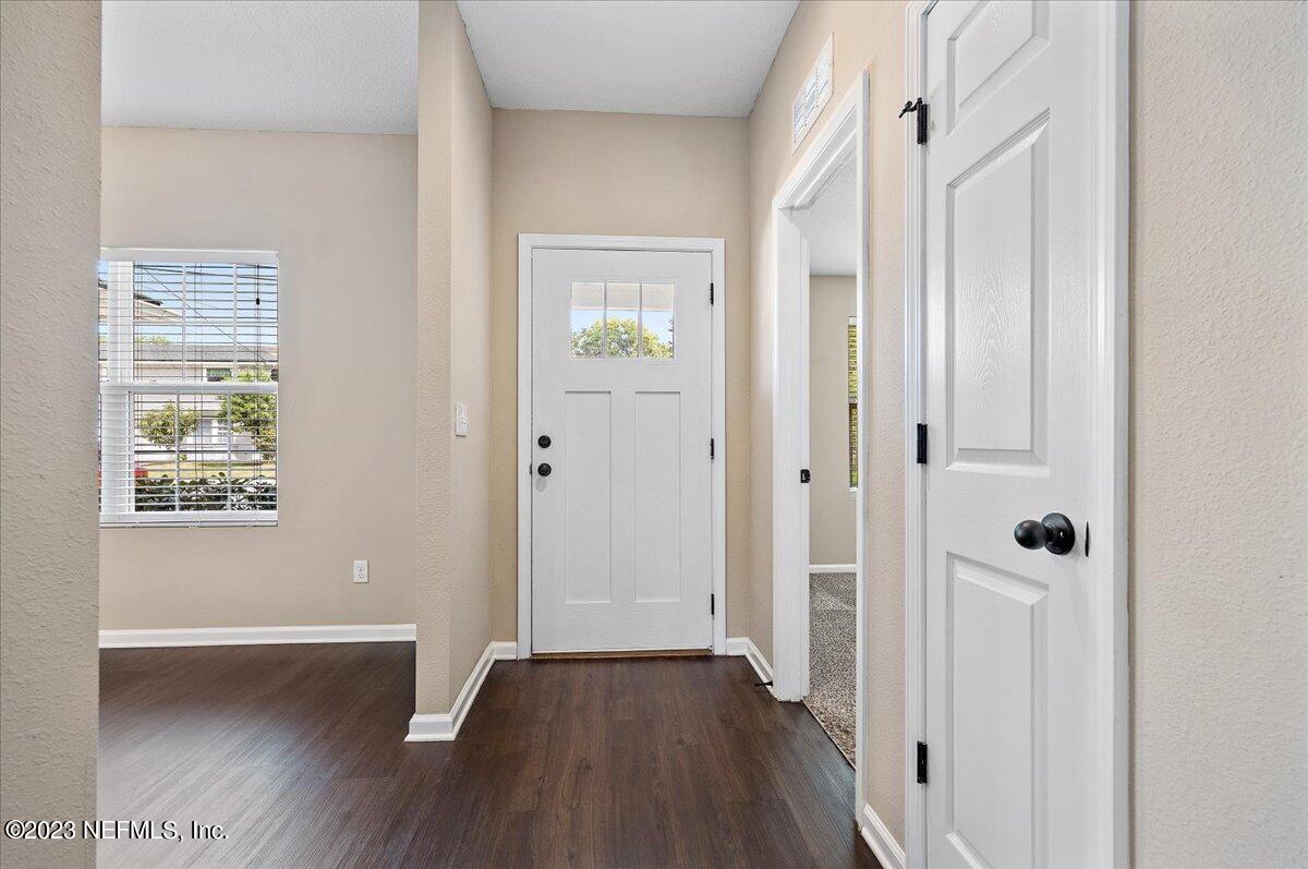 5418 Manfields Place Jacksonville, FL 32207 - Photo 4 of 21 a view of a hallway with wooden floor and a bathroom