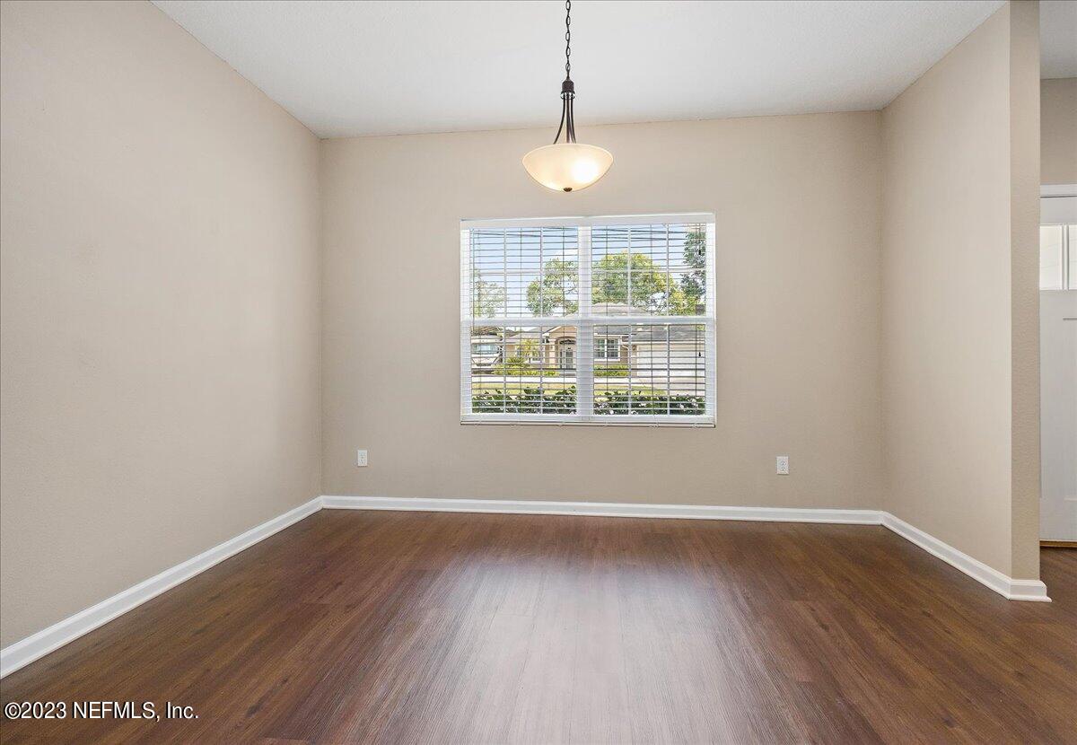 5418 Manfields Place Jacksonville, FL 32207 - Photo 5 of 21 a view of an empty room with wooden floor and a window