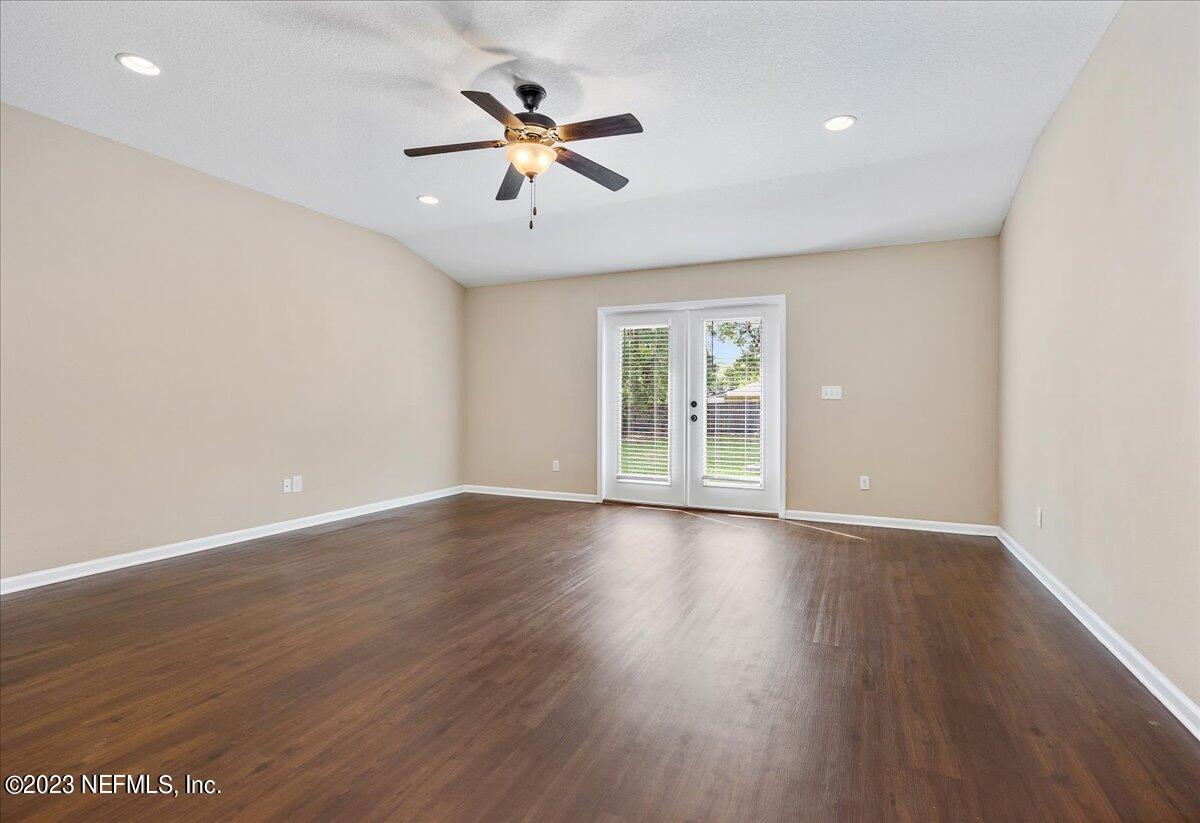 5418 Manfields Place Jacksonville, FL 32207 - Photo 8 of 21 an empty room with wooden floor and windows