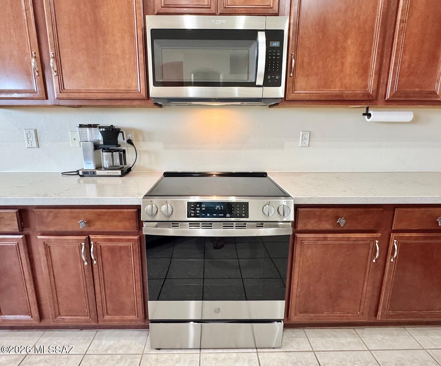 10835 South Heart Break Ridge Place Vail, AZ 85641 - Photo 17 of 49 a kitchen with stainless steel appliances granite countertop a stove a microwave and a sink