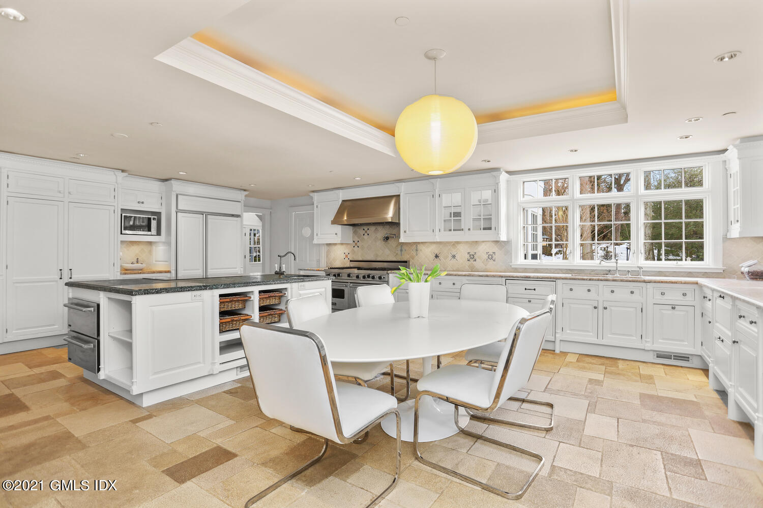 8 Cathlow Drive Riverside, CT 06878 - Photo 19 of 44 a kitchen with a dining table chairs and white appliances
