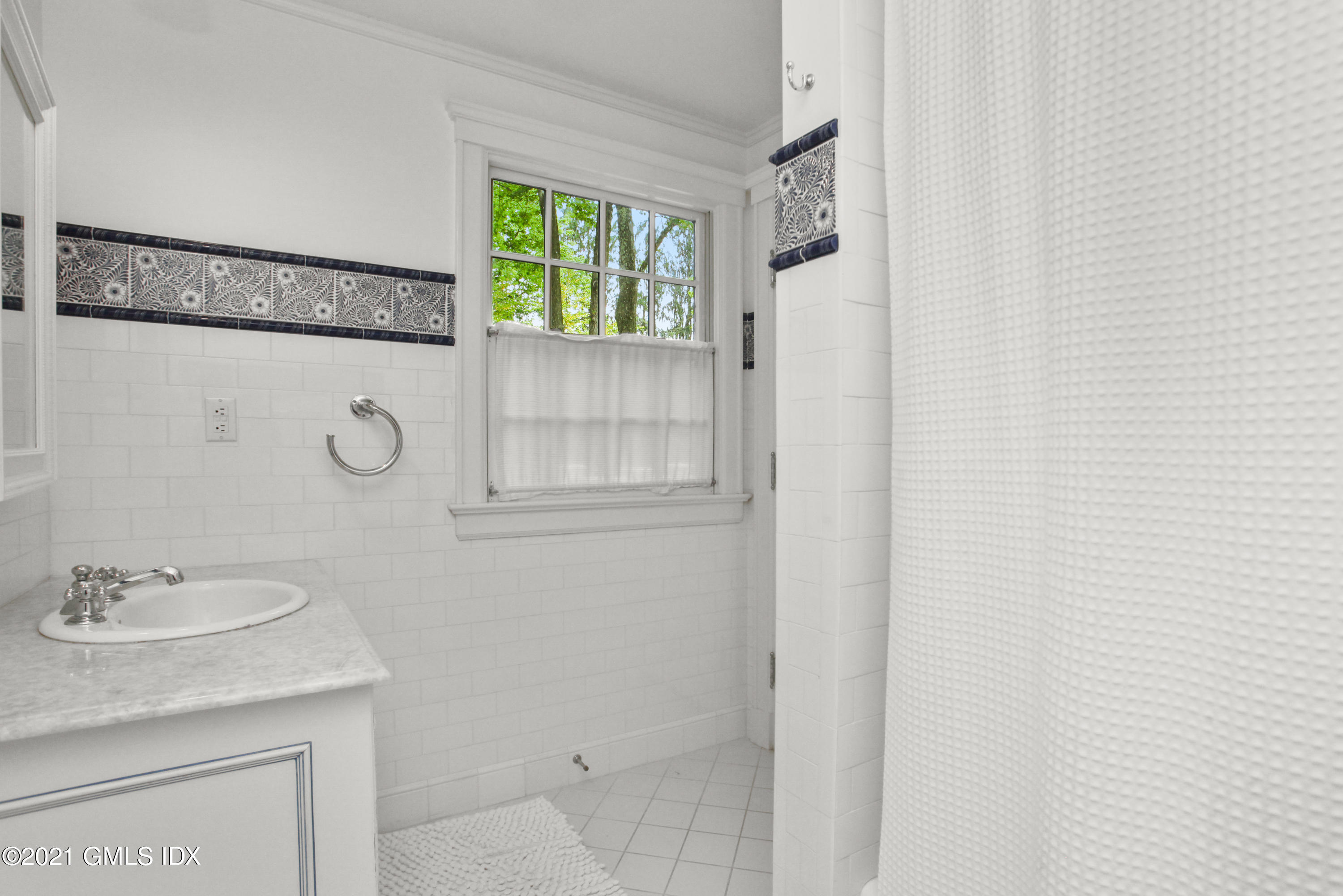 8 Cathlow Drive Riverside, CT 06878 - Photo 34 of 44 a bathroom with a granite countertop sink a mirror and a shower
