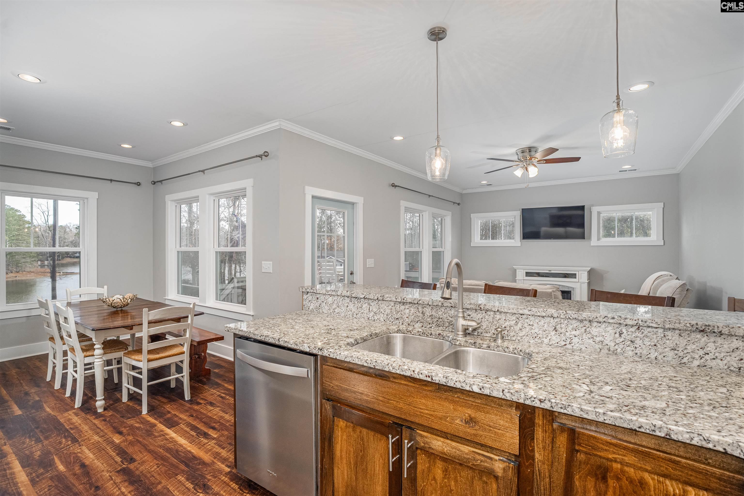 649 Sandbar Road Chapin, SC 29036 - Photo 12 of 40 a kitchen with granite countertop kitchen island stainless steel appliances a sink and a table