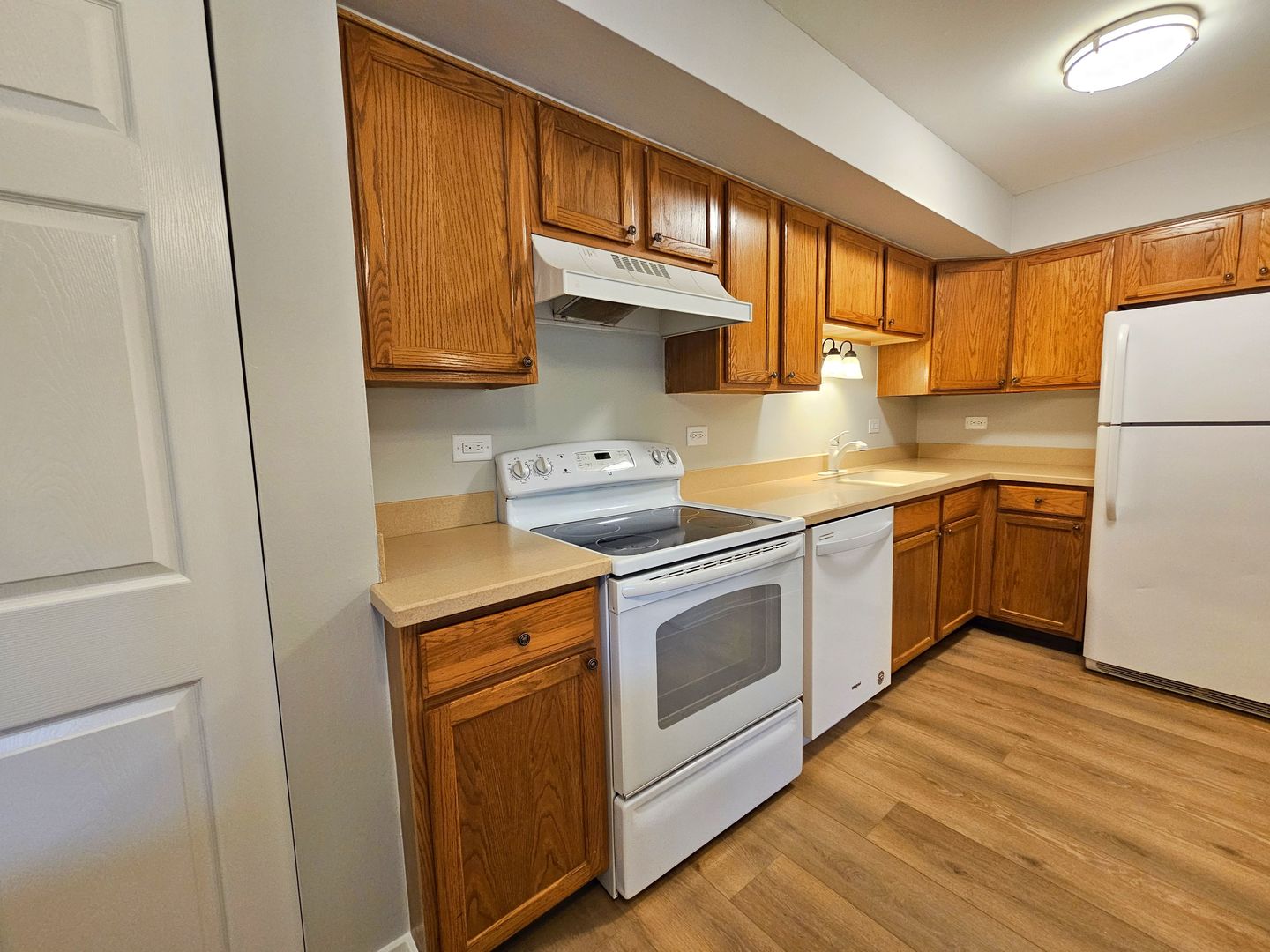 2214 South Goebbert Road, Unit 276 Arlington Heights, IL 60005 - Photo 4 of 17 a kitchen with a sink cabinets stainless steel appliances and a window