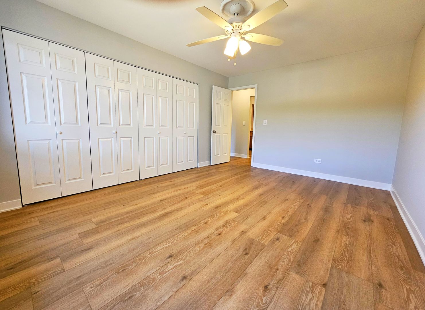 2214 South Goebbert Road, Unit 276 Arlington Heights, IL 60005 - Photo 7 of 17 a view of an empty room with wooden floor