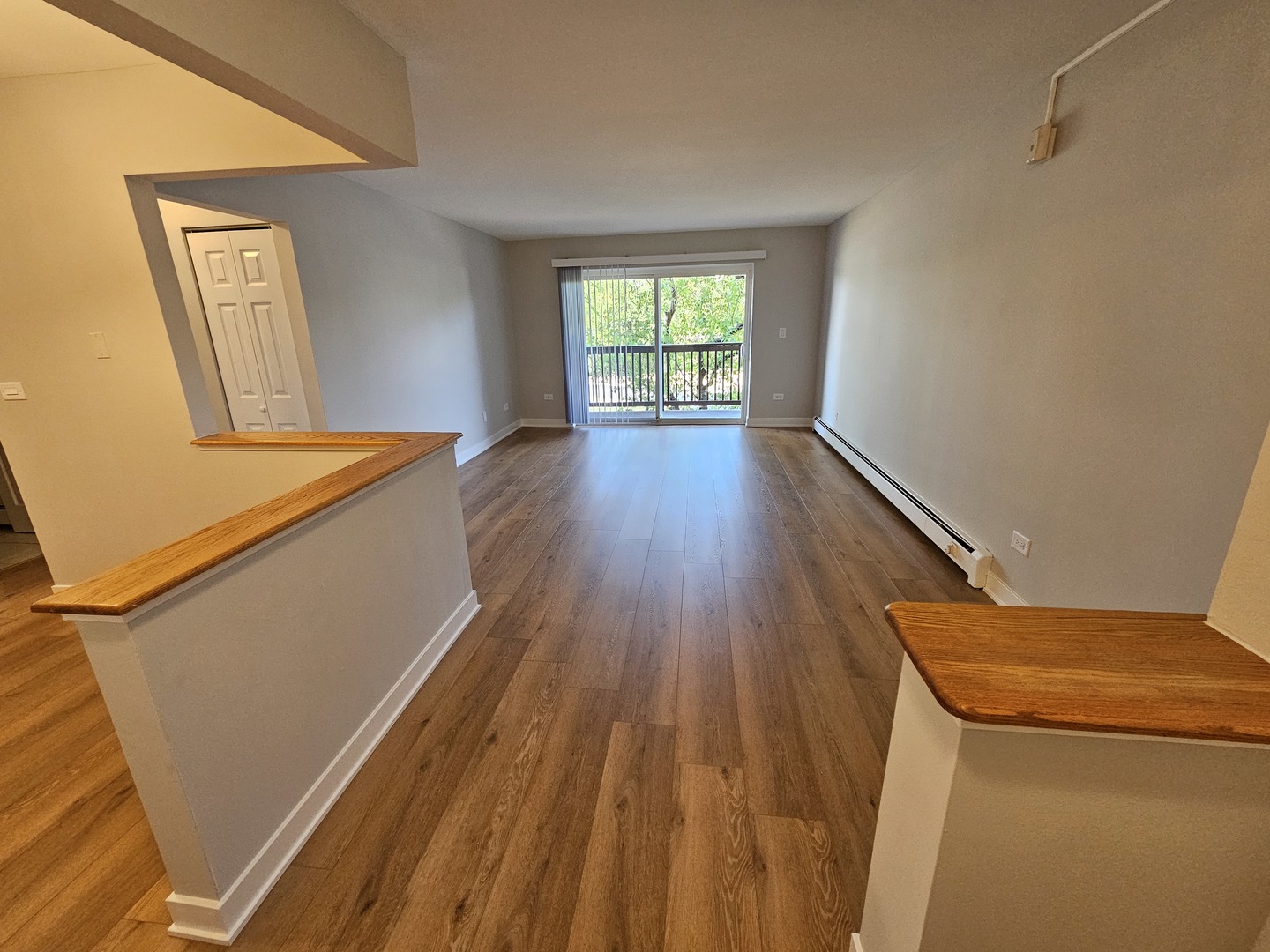 2214 South Goebbert Road, Unit 276 Arlington Heights, IL 60005 - Photo 9 of 17 a view of a room with wooden floor and window