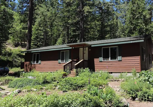 a front view of house with yard and green space