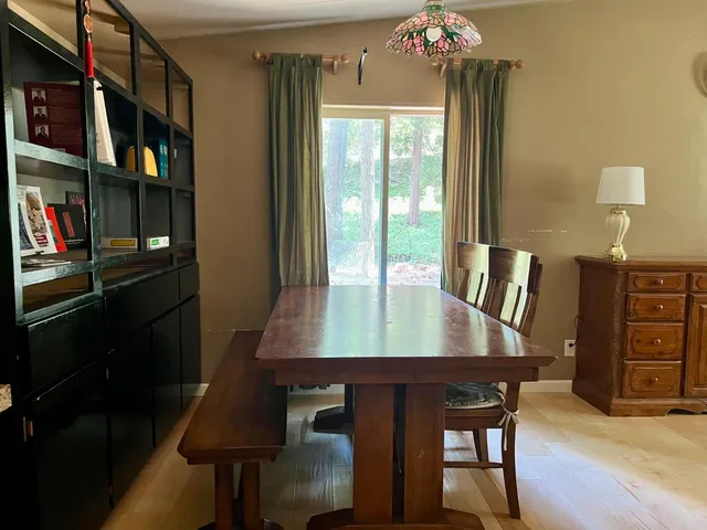 a view of a dining room with furniture and a chandelier