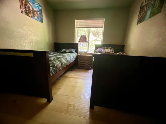 a bedroom with bed and window