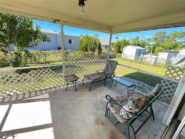 a balcony with furniture and a potted plant