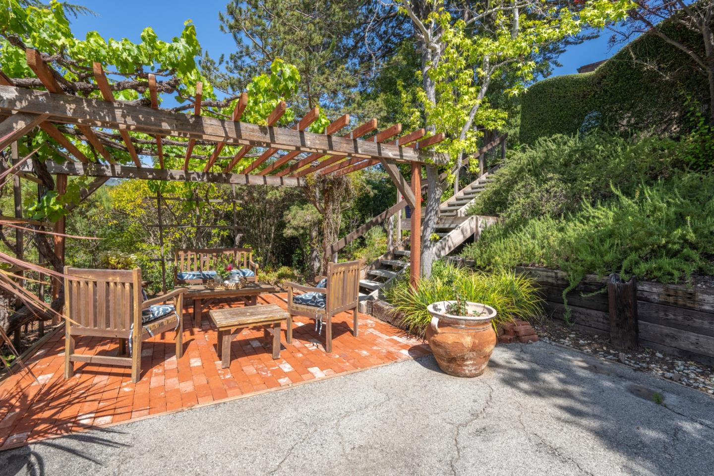 46 Middle Canyon Road Carmel Valley, CA 93924 - Photo 56 of 74 a view of a patio with table and chairs and potted plants