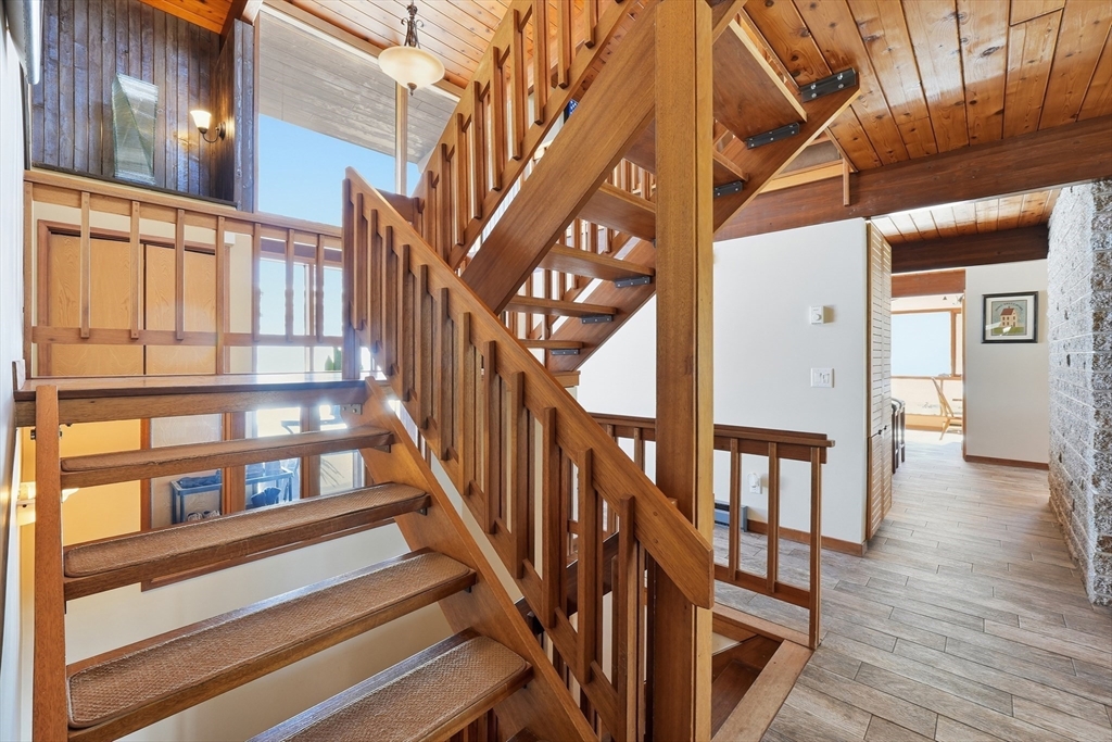 1023 North Woodstock Road Southbridge, MA 01550 - Photo 28 of 41 a view of staircase with lots of frames on wall and a large window