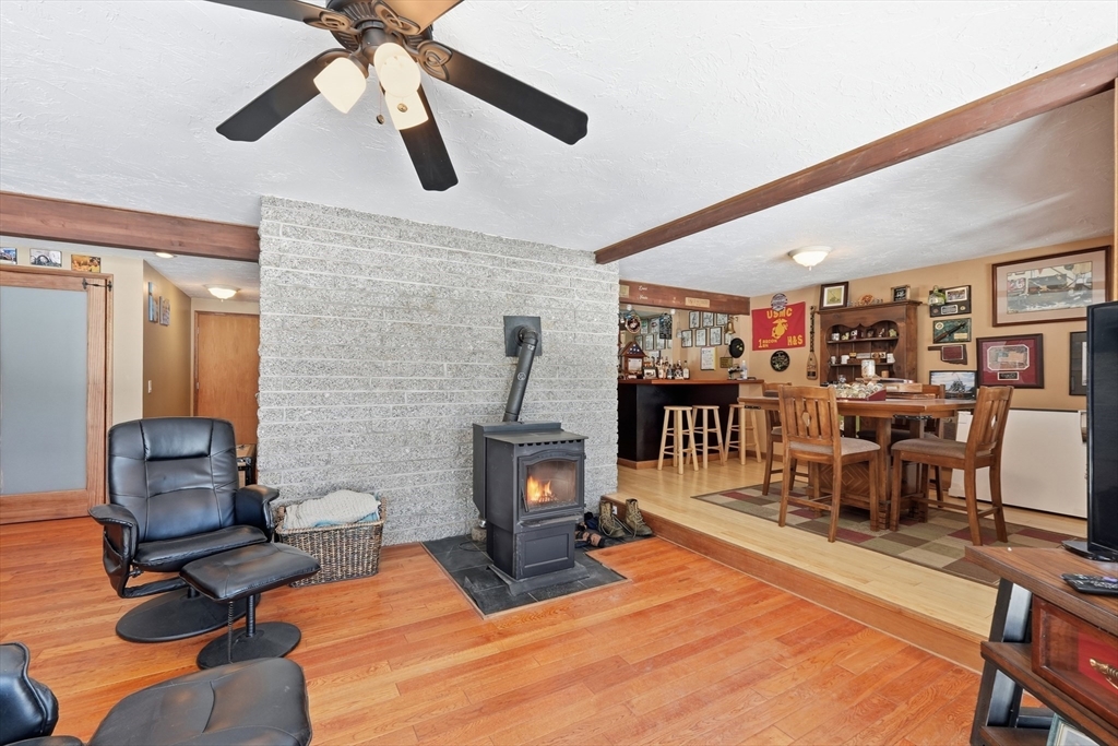 1023 North Woodstock Road Southbridge, MA 01550 - Photo 40 of 41 a living room with furniture a wooden floor and a ceiling fan