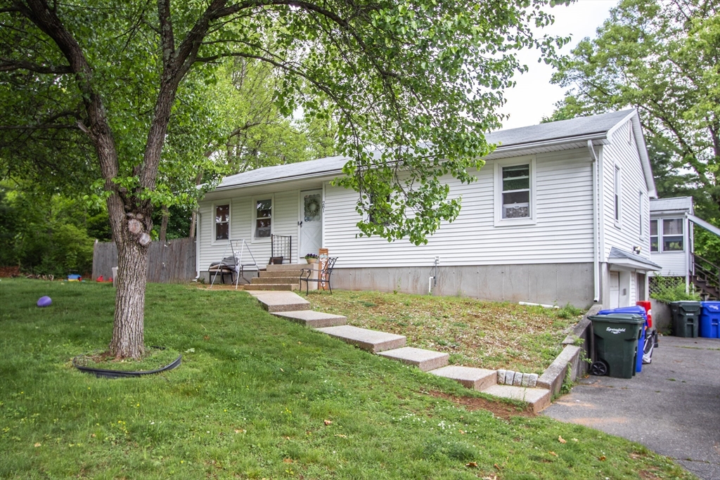 281 Bolton Street Springfield, MA 01119 - Photo 1 of 18 a front view of a house with garden