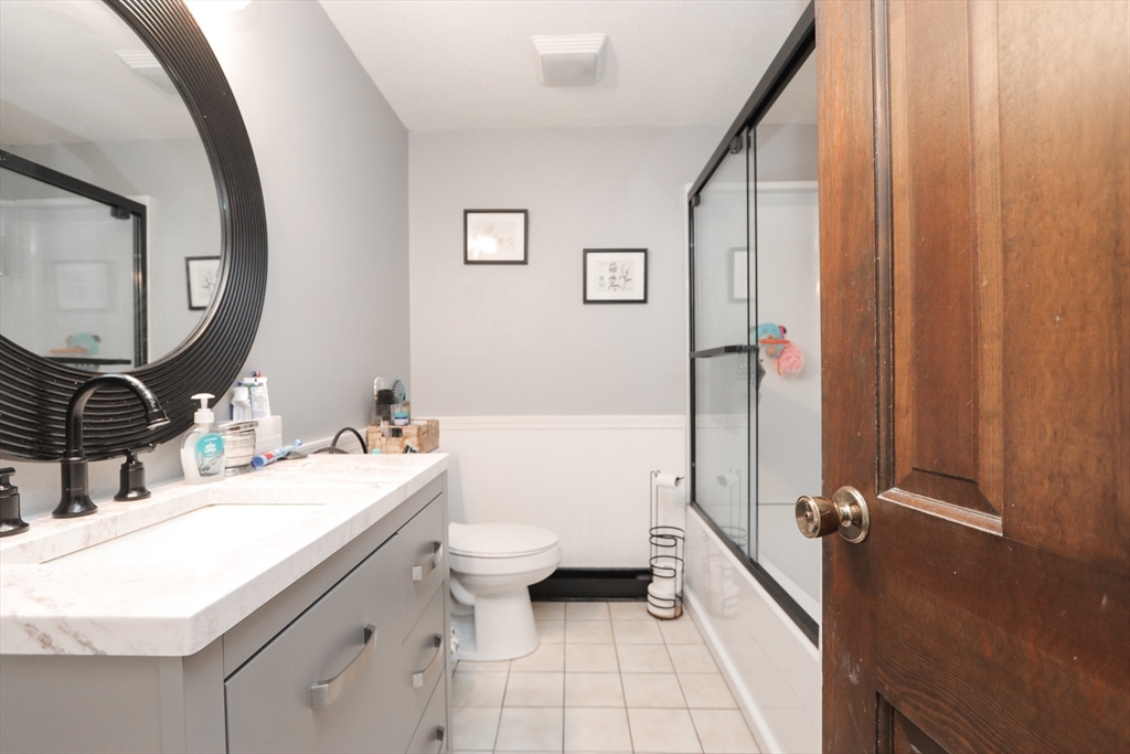 281 Bolton Street Springfield, MA 01119 - Photo 9 of 18 a bathroom with a granite countertop sink mirror vanity and toilet