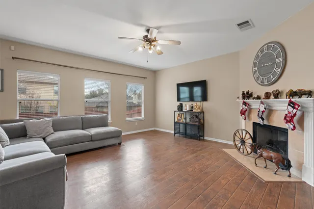 a living room with furniture a clock and a window