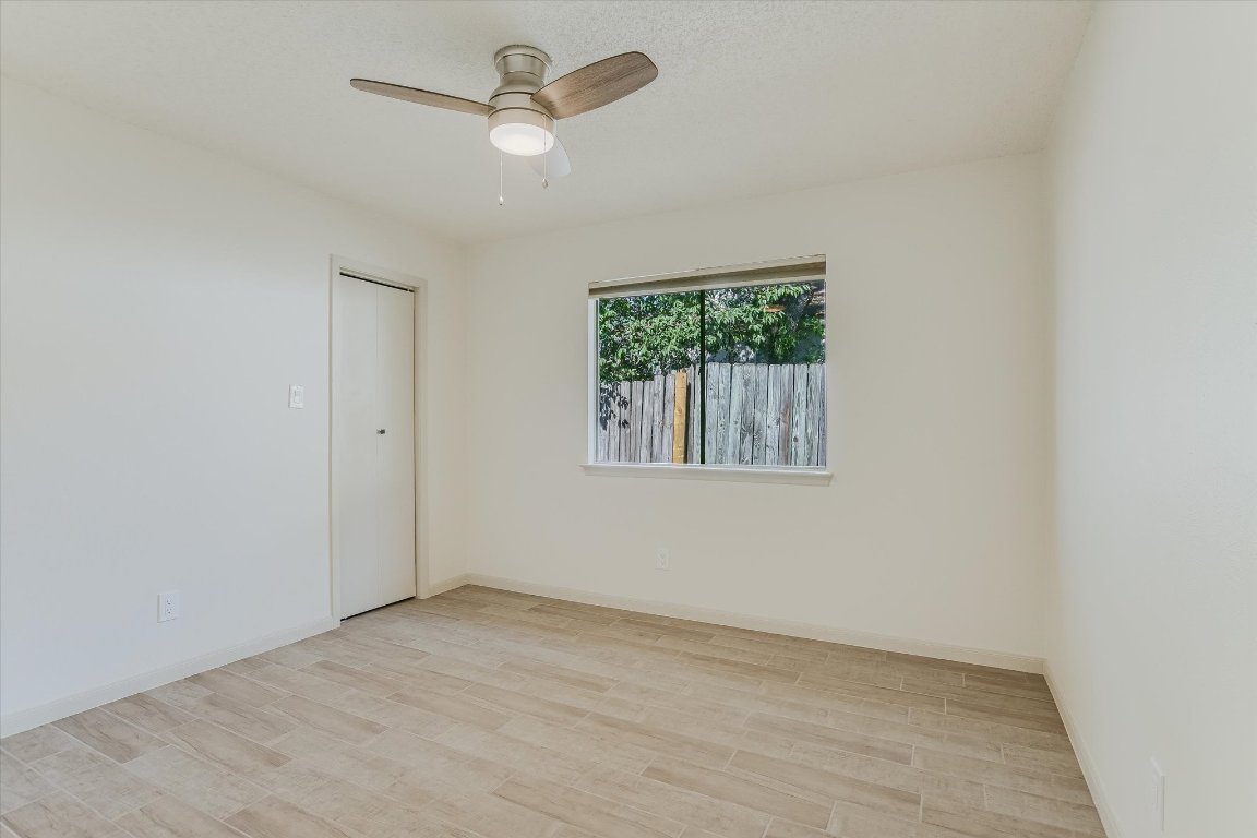 8415 Fathom Circle, Unit B Austin, TX 78750 - Photo 8 of 17 an empty room with a window and a ceiling fan