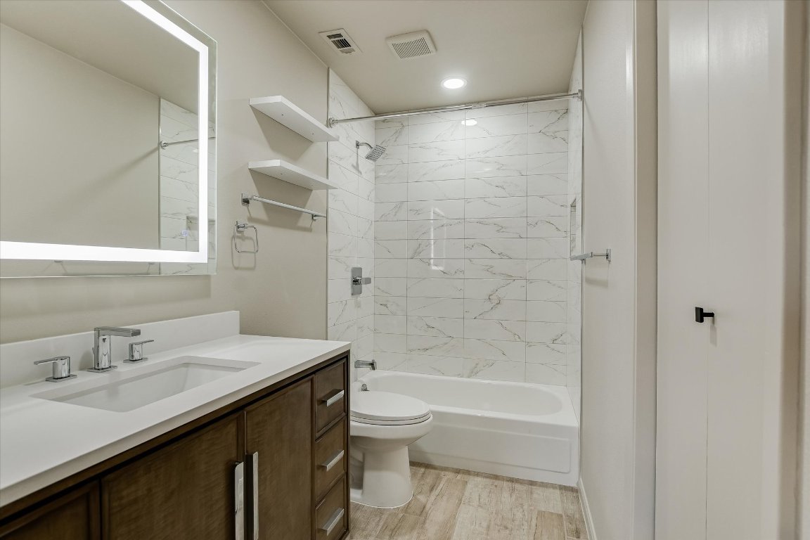 8415 Fathom Circle, Unit B Austin, TX 78750 - Photo 5 of 17 a bathroom with a sink a toilet and shower