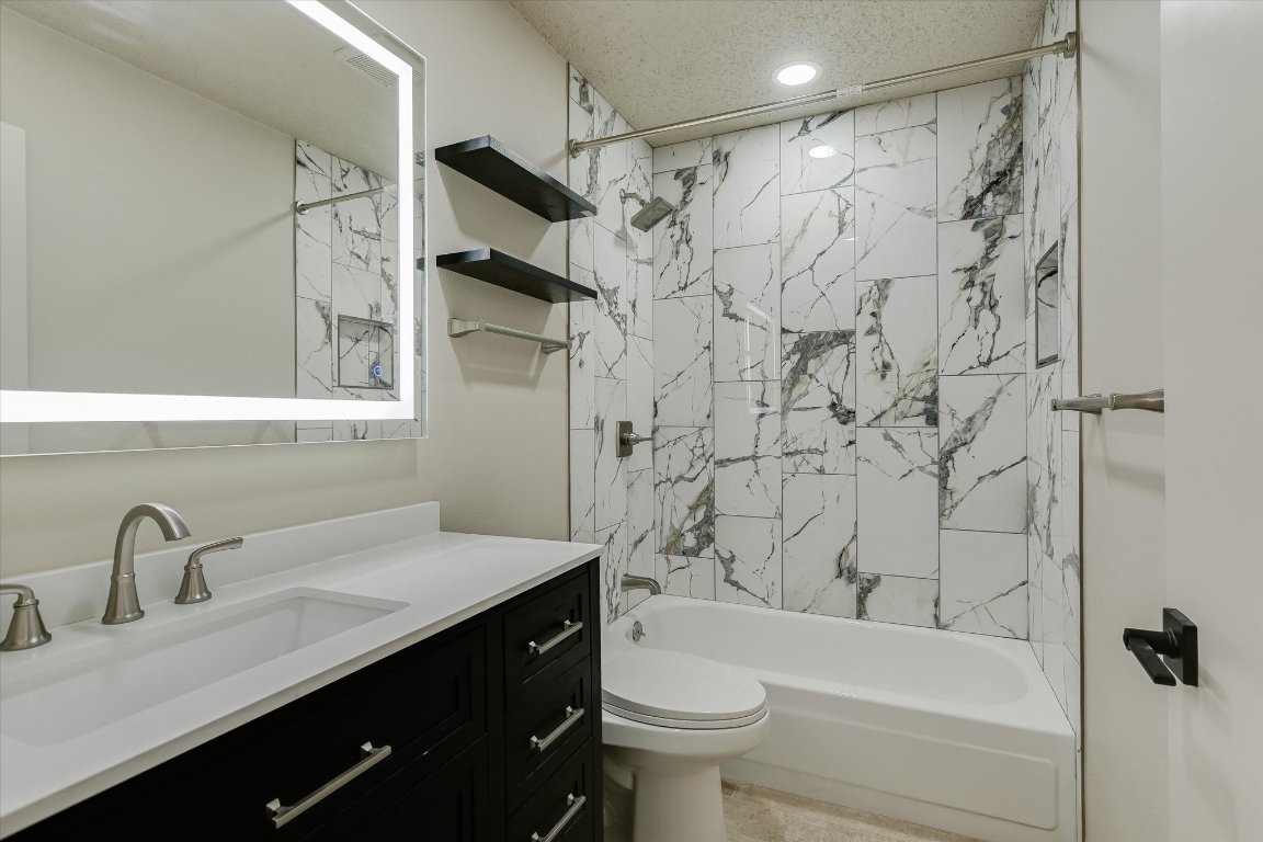 8415 Fathom Circle, Unit B Austin, TX 78750 - Photo 7 of 17 a bathroom with a sink a toilet and a bathtub