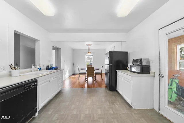 a large kitchen with a table and chairs