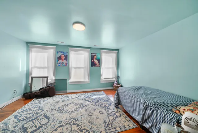 a bedroom with bed and window