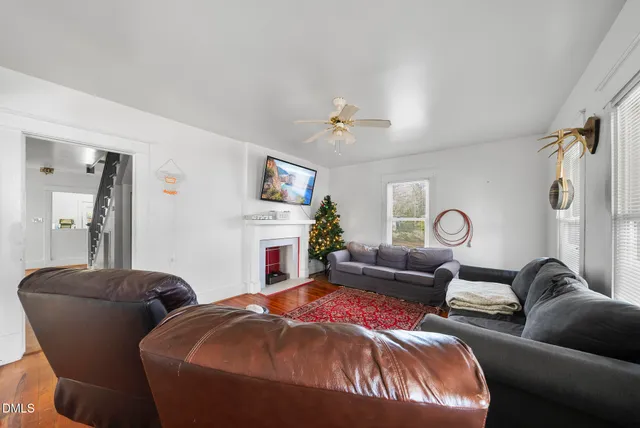 a living room with furniture a fireplace and a window