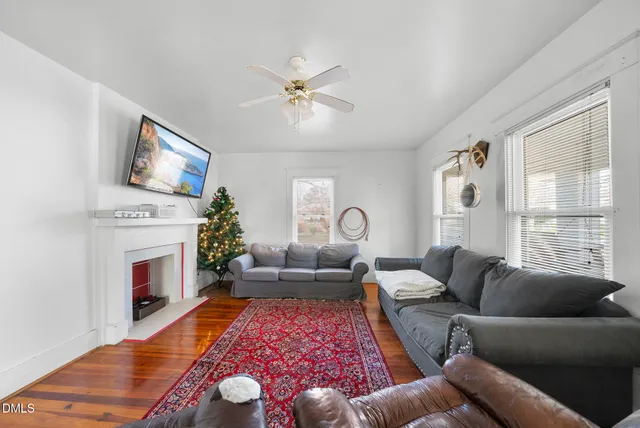 a living room with furniture fireplace and window