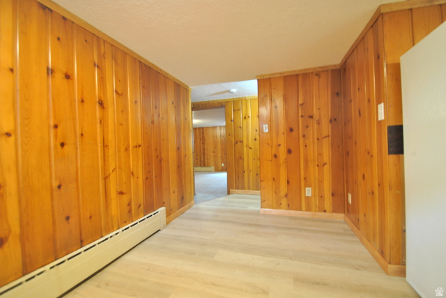 33 North 200 East Logan, UT 84321 - Photo 54 of 54 Hall featuring a baseboard radiator, wood finished floors, and wood walls