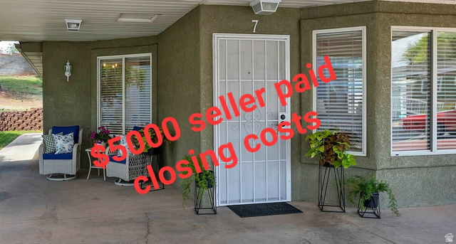 2990 East Riverside Drive, Unit 7 St. George, UT 84790 - Photo 1 of 36 Covered front patio featuring stucco exterior, security screen door, and multiple windows with blinds