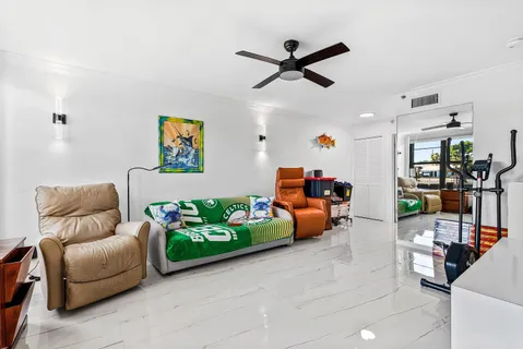 a living room with furniture and a floor to ceiling window