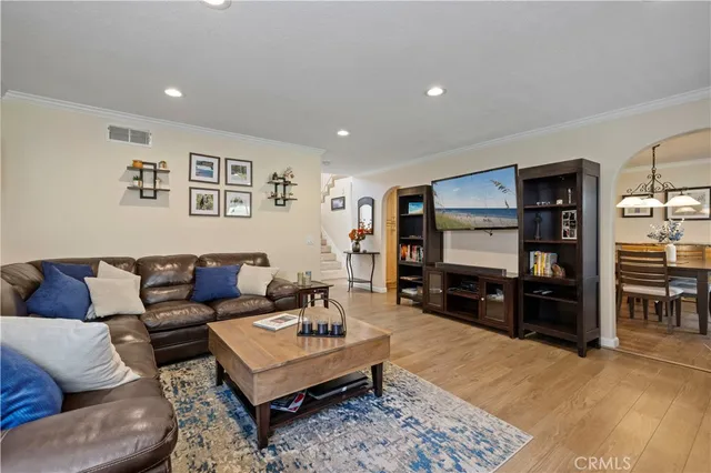 a dining room with stainless steel appliances kitchen island granite countertop a dining table chairs and a refrigerator