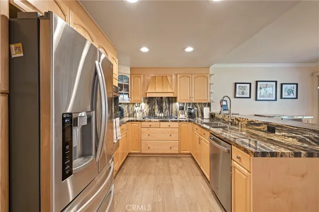 a kitchen with kitchen island granite countertop white cabinets and a sink