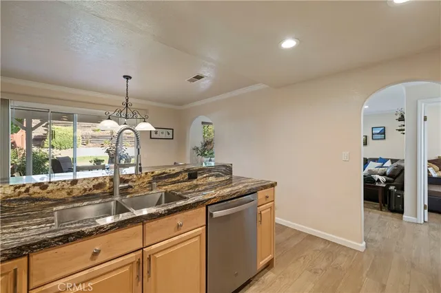 a kitchen with stainless steel appliances a refrigerator sink and cabinets