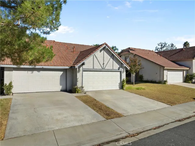 a view of house with outdoor space and parking