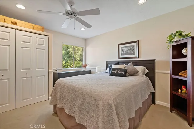 a bedroom with a large bed and a chandelier