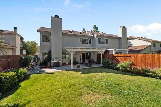 an aerial view of a house with swimming pool and outdoor seating