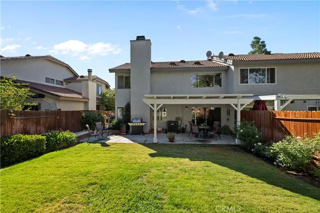 an aerial view of a house with a yard and outdoor seating