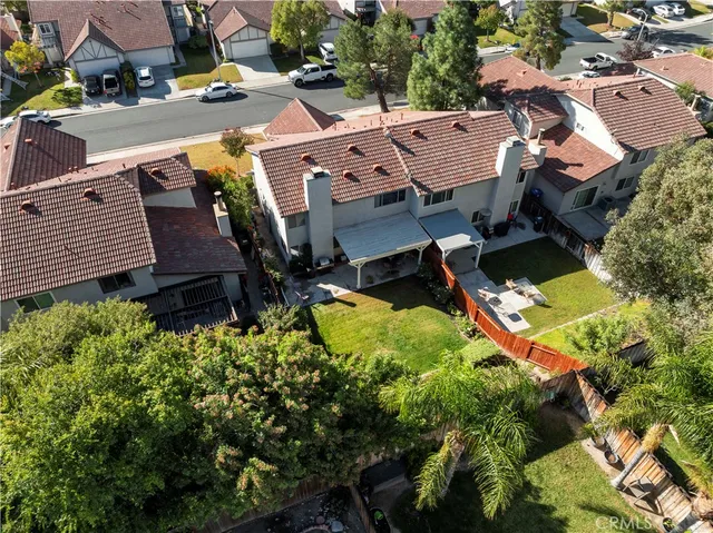 an aerial view of a house with a yard