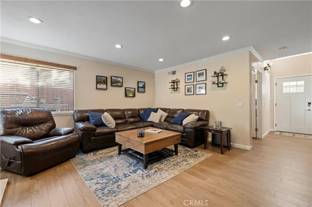 a living room with furniture a fireplace and a large window