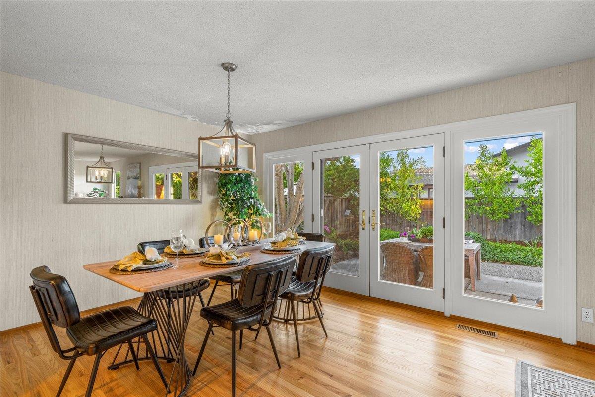 877 West Knickerbocker Drive Sunnyvale, CA 94087 - Photo 16 of 51 a dining room with furniture a chandelier and wooden floor