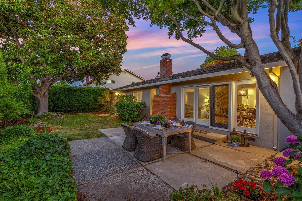 877 West Knickerbocker Drive Sunnyvale, CA 94087 - Photo 41 of 51 a view of a patio with table and chairs potted plants and a large tree