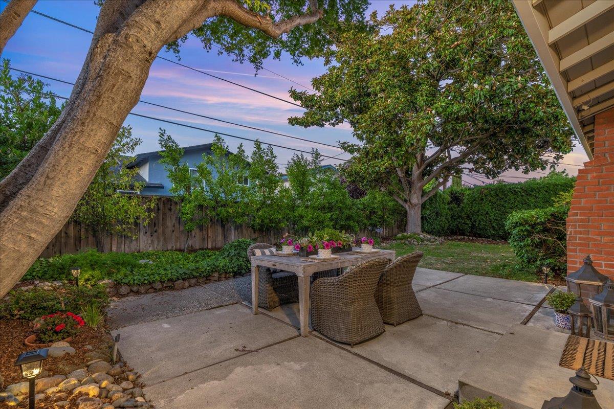 877 West Knickerbocker Drive Sunnyvale, CA 94087 - Photo 43 of 51 a view of a patio with table and chairs potted plants and a large tree