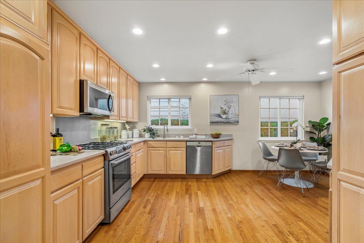 877 West Knickerbocker Drive Sunnyvale, CA 94087 - Photo 10 of 51 a kitchen with a sink wooden floor stainless steel appliances and cabinets