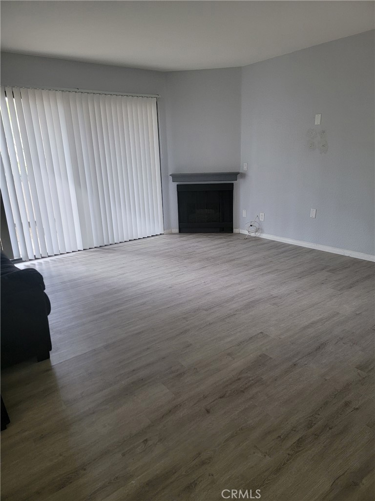3532 West Stonepine Lane, Unit B Anaheim, CA 92804 - Photo 4 of 9 a view of empty room with wooden floor and fan