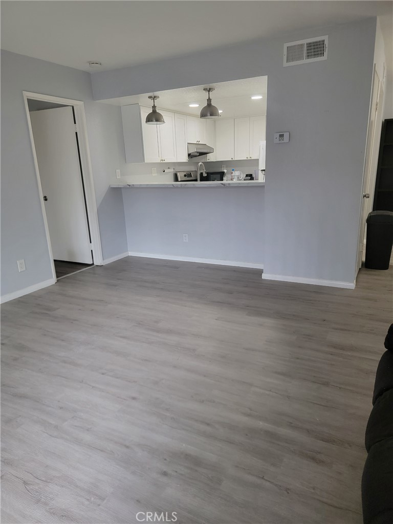 3532 West Stonepine Lane, Unit B Anaheim, CA 92804 - Photo 5 of 9 a view of a kitchen with a sink and wooden floor