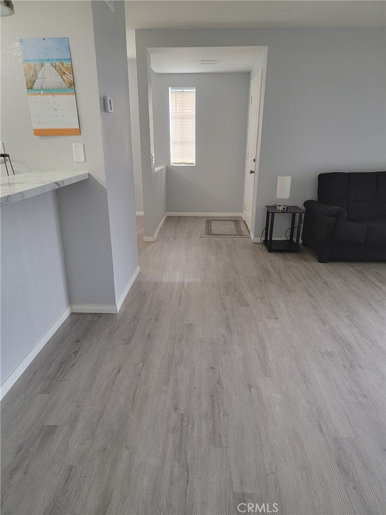 3532 West Stonepine Lane, Unit B Anaheim, CA 92804 - Photo 7 of 9 a view of a livingroom with wooden floor and a window